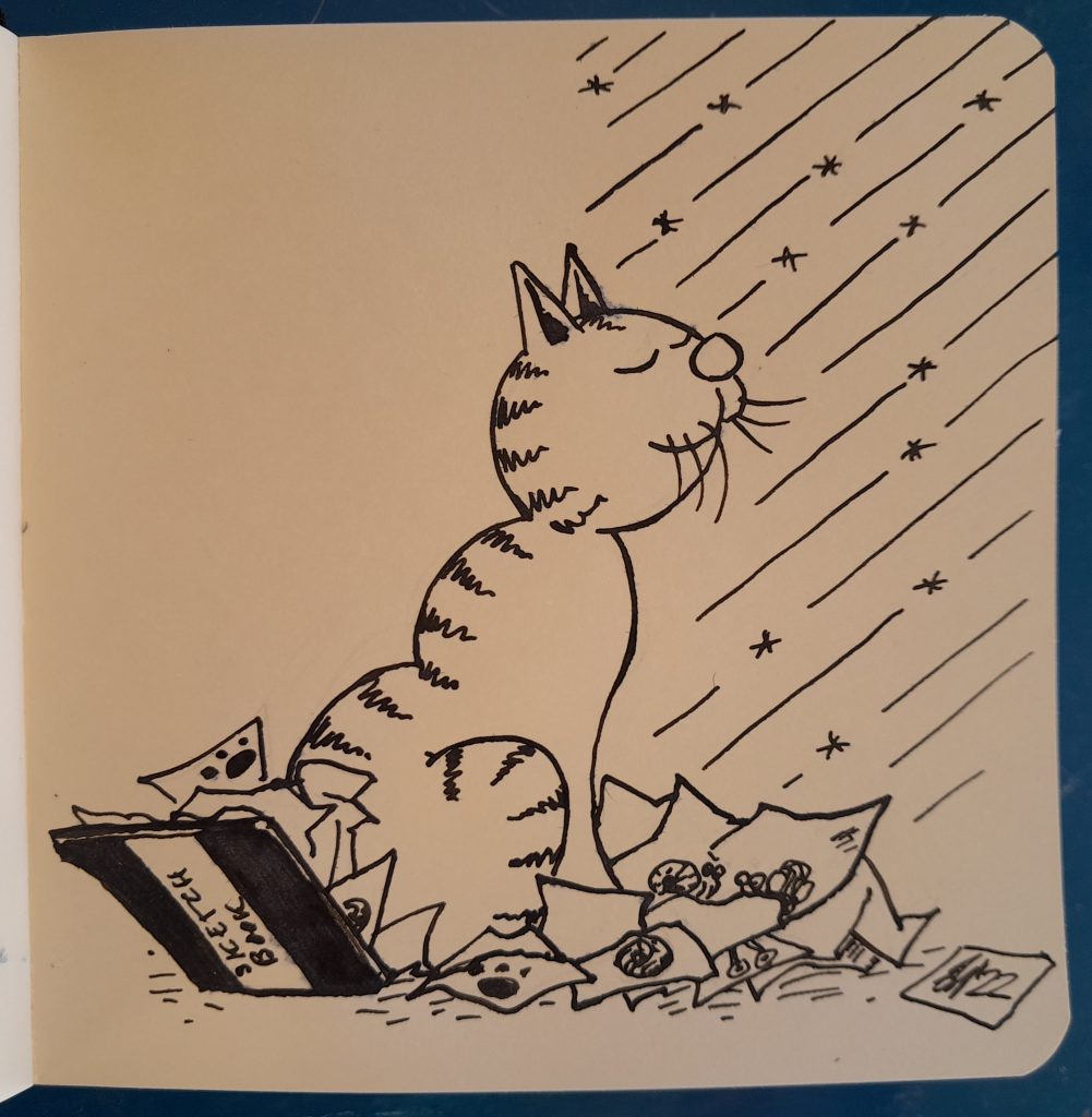 A cat, looking happy and satisfied, sitting on a pile of crumpled sketchbook pages, in the sunlight coming in. 